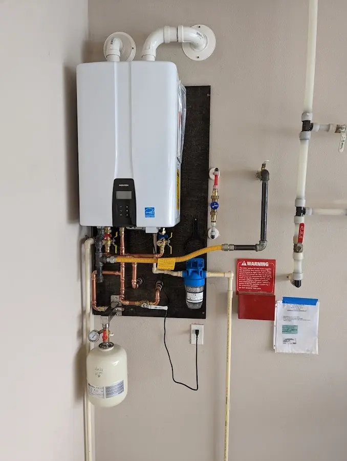 Professional plumber installing copper piping in a Napili-Honokowai home